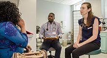 two doctors talking to a patient